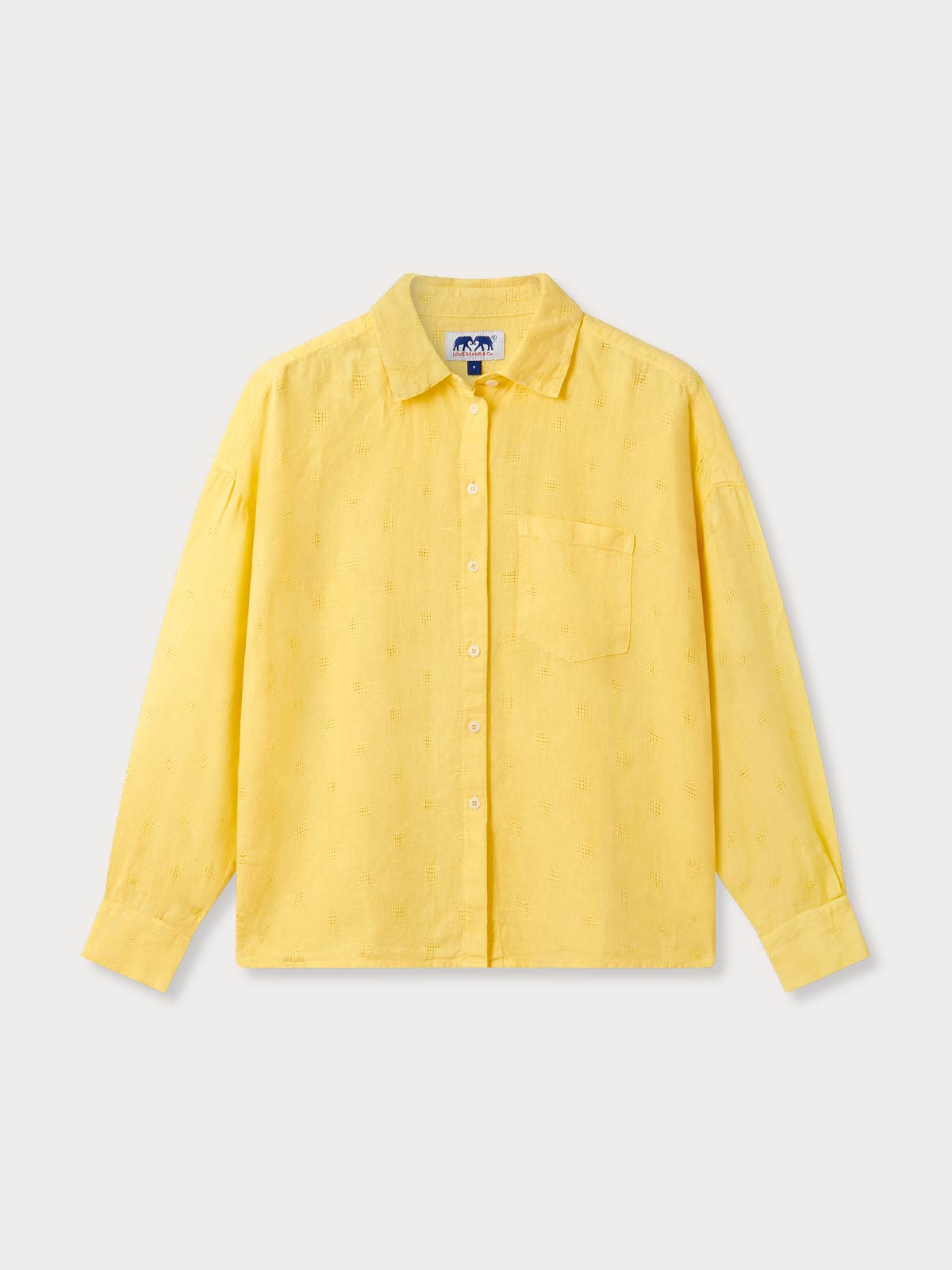 front view of womens yellow linen shirt. Button-up design with long sleeves and a left breast pocket.