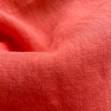 Close-up of coral-colored linen fabric from the Men's Coral Abaco Linen Shirt.