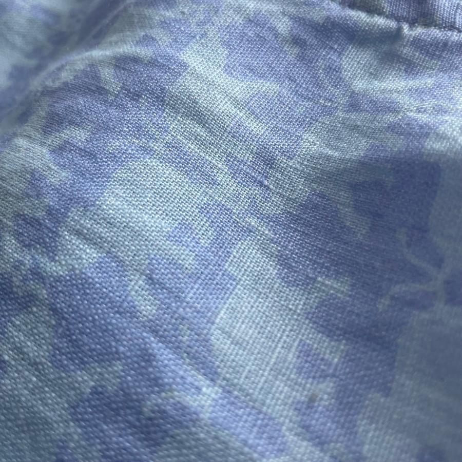 Close-up image of the blue elephant print on the Men's Elephant Dance Blue Abaco Linen Shirt, crafted from 100% premium linen. The fabric features a serene pale blue hue with an intricate elephant pattern.