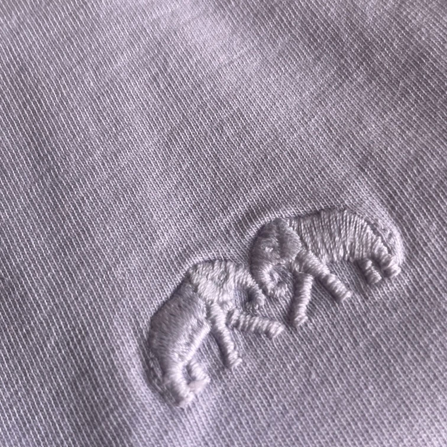 Close-up of embroidered elephants on Boys Lavender Lockhart T-Shirt, showcasing fabric texture and pastel lavender color.