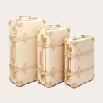 Three Globe-Trotter Safari 20" Trolley Cases in differing sizes, featuring vintage design elements and beige leather accents. All trolley cases are part of a limited edition collection by LOVE BRAND & Co., showcasing their signature 'Elephant Palace' print.