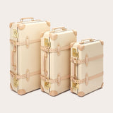 Three Globe-Trotter Safari 20" Trolley Cases in differing sizes, featuring vintage design elements and beige leather accents. All trolley cases are part of a limited edition collection by LOVE BRAND & Co., showcasing their signature 'Elephant Palace' print.