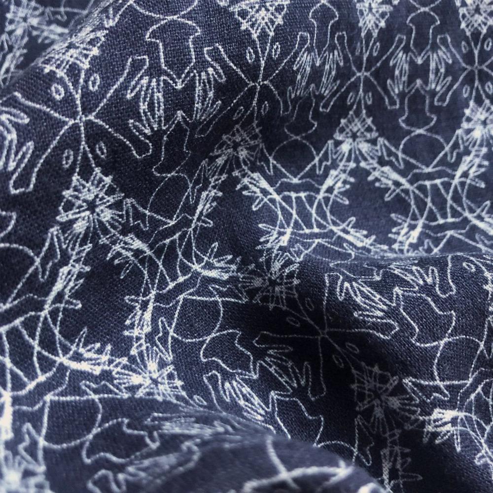 Close-up view of the Men's Going Gecko Abaco Linen Shirt fabric showing the intricate line drawing print of geckos, inspired by the conservation of the Union Island Gecko. Crafted from soft and breathable linen.