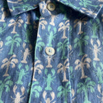 Close-up of the Men's Party Like a Lobstar Abaco Linen Shirt with dancing lobsters and swaying palm trees pattern.