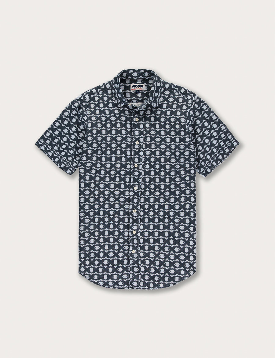 Front view of Men's Rhino Rhythm Manjack Linen Shirt. Men's linen shirt featuring geometric rhino print with button-up design and short sleeves.