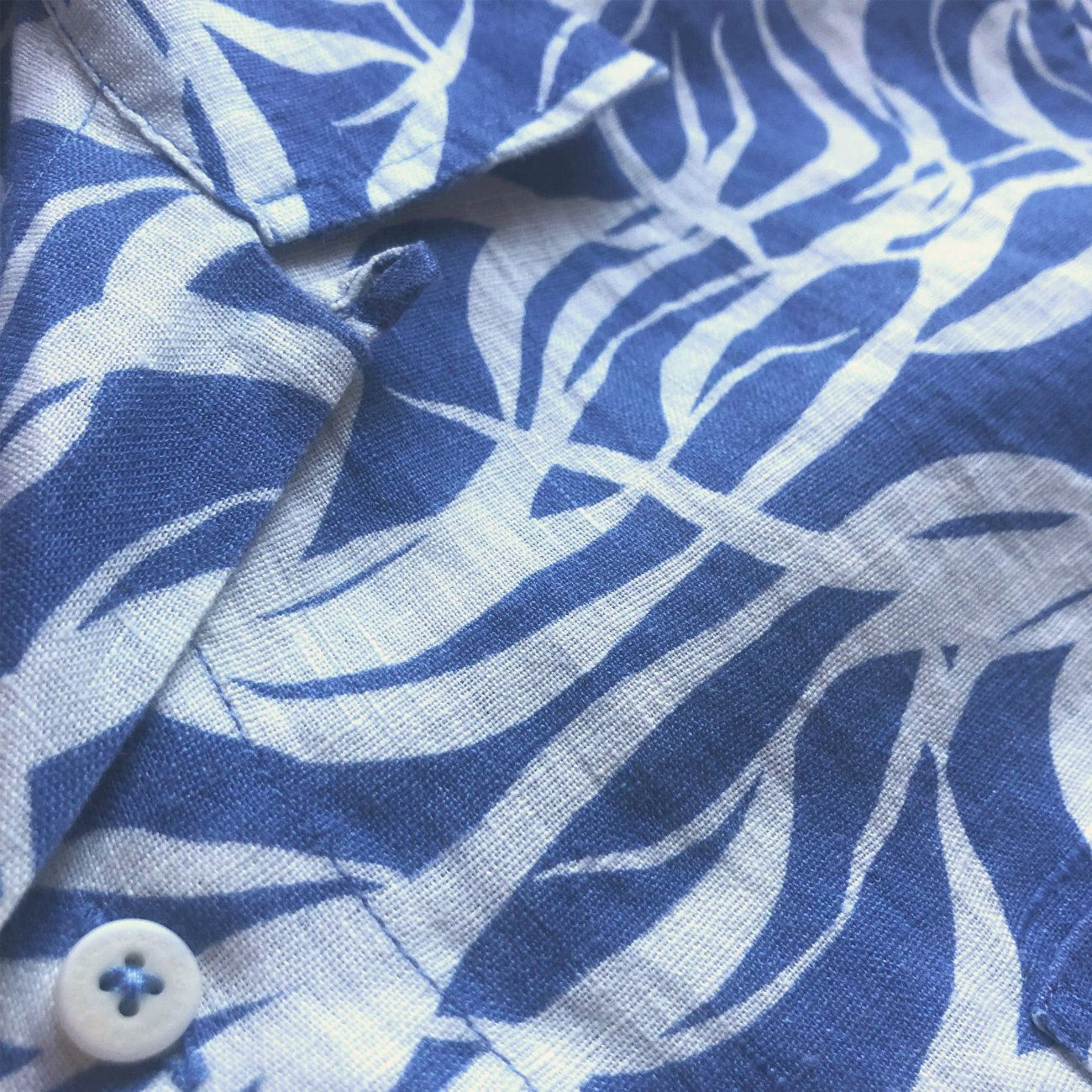 Close-up view of the Men's Kelp Arawak Linen Shirt featuring a sea blue and white kelp-inspired print.