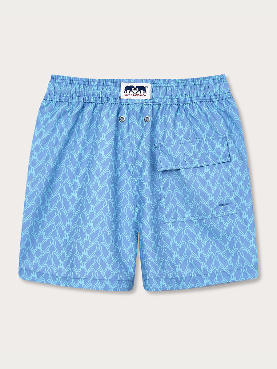 Men's Posidonia y el Mar Staniel Swim Shorts in light blue with a seagrass pattern, featuring an elastic waistband, two buttoned drainage eyelets, and a side flap pocket.