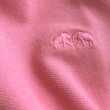 Close-up image of the fabric texture and embroidered logo on the Watermelon Pensacola mens Polo Shirt in bright pink color.