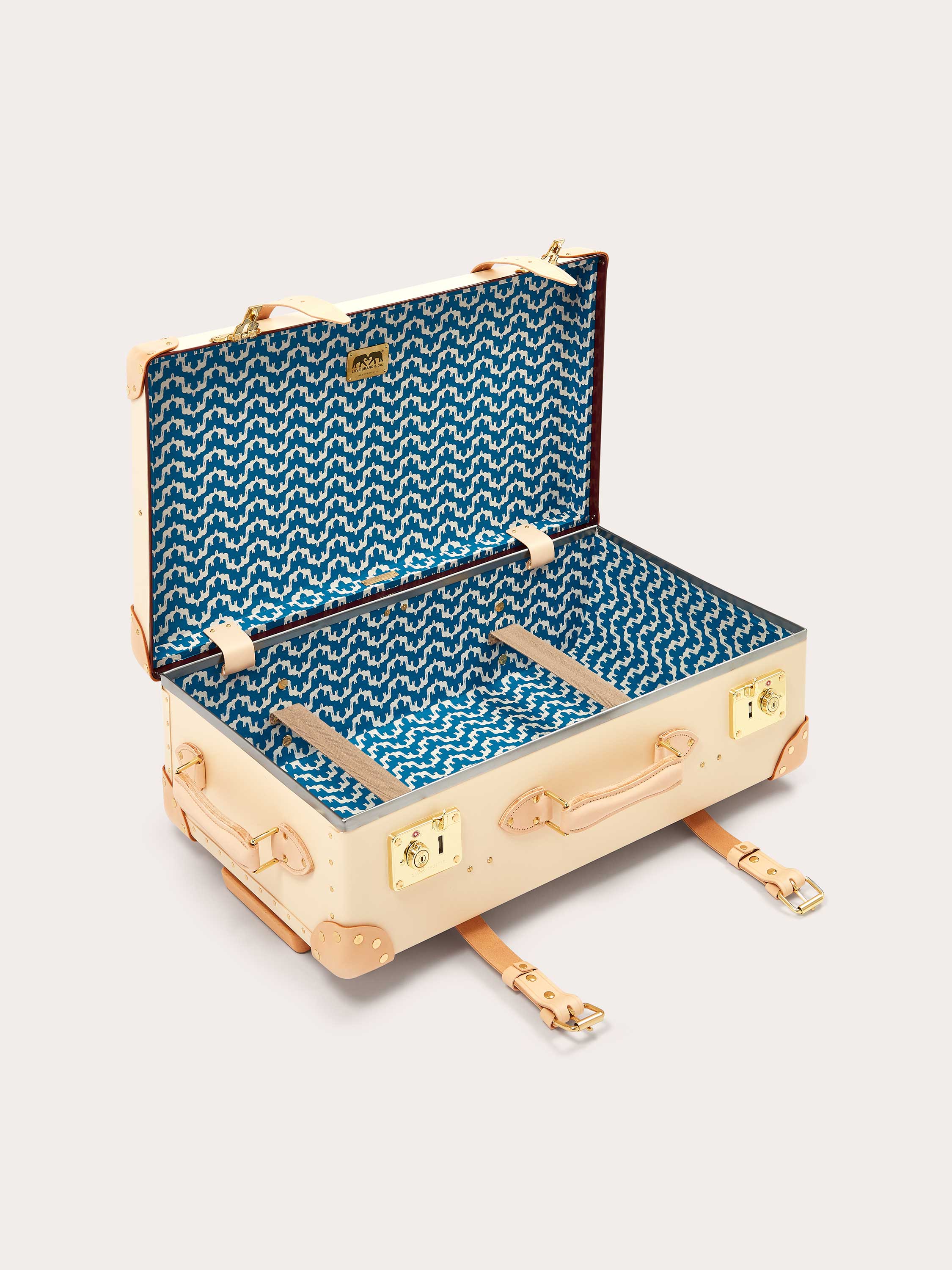 Globe-Trotter Safari 26" Trolley Case with LOVE BRAND & Co.'s 'Elephant Palace' print lining, beige exterior, leather straps, and brass hardware.