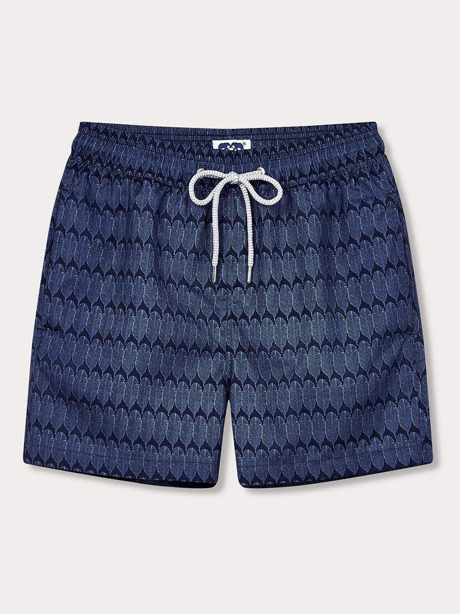 A pair of navy blue swim shorts with a geometric pattern, featuring a drawstring waistband.