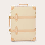 Globe-Trotter Safari 20" Trolley Case in cream with tan leather straps and corners. Trolley case featuring a durable handle on top and side for easy carrying.