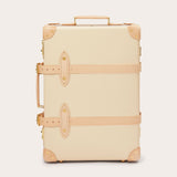 Globe-Trotter Safari 20" Trolley Case in cream with tan leather straps and corners. Trolley case featuring a durable handle on top and side for easy carrying.